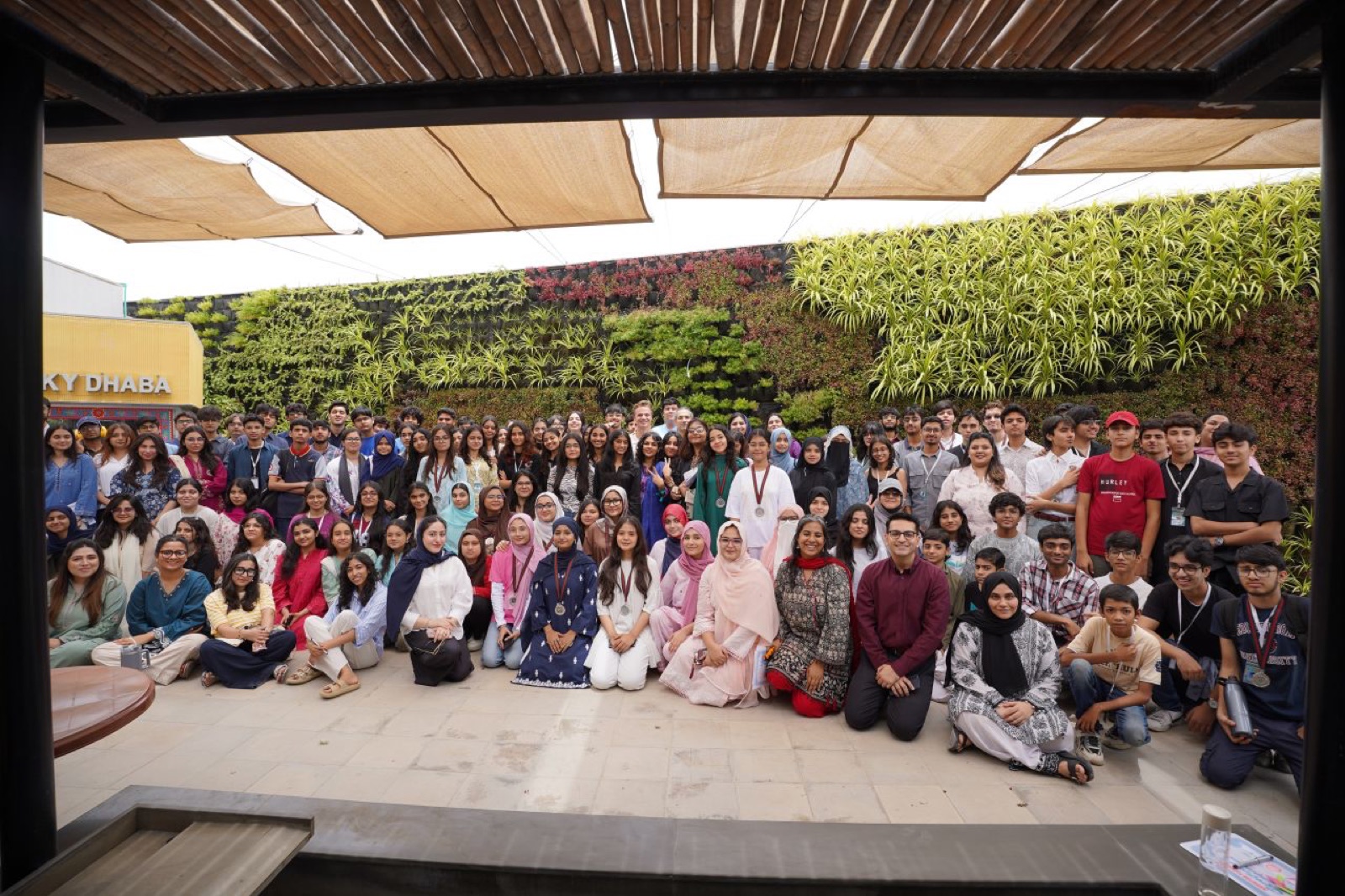 The Innovation Playground cohort gathered for a group photo in a Habib University courtyard